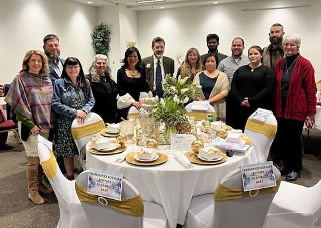 image of the tvcc foundation board standing next to the banquet table the foundation decorated